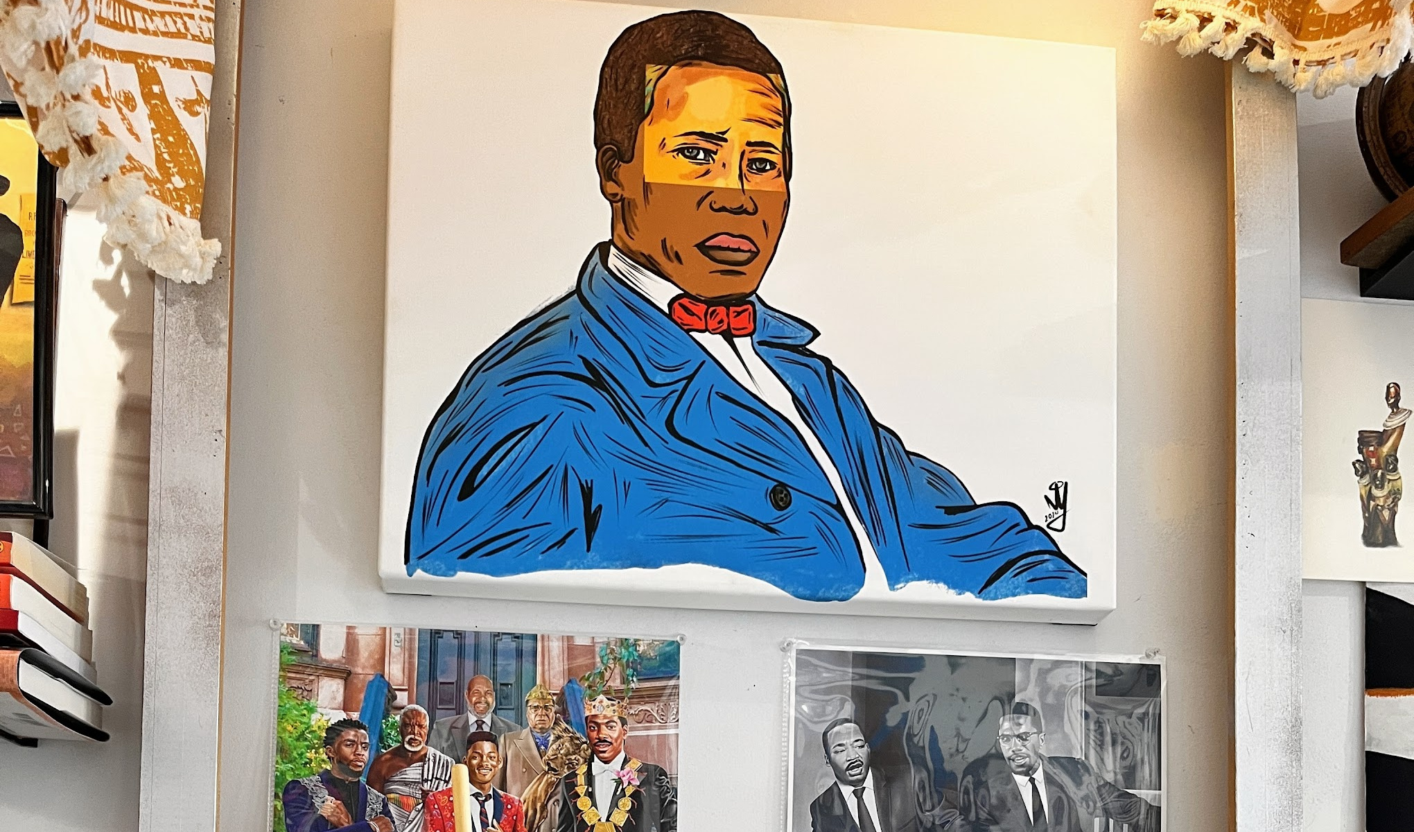 Exhibit A’s portrait of William Still hangs inside her Container Village studio.