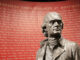 Thomas Jefferson statue at Monticello in front of a wall remembering people enslaved there