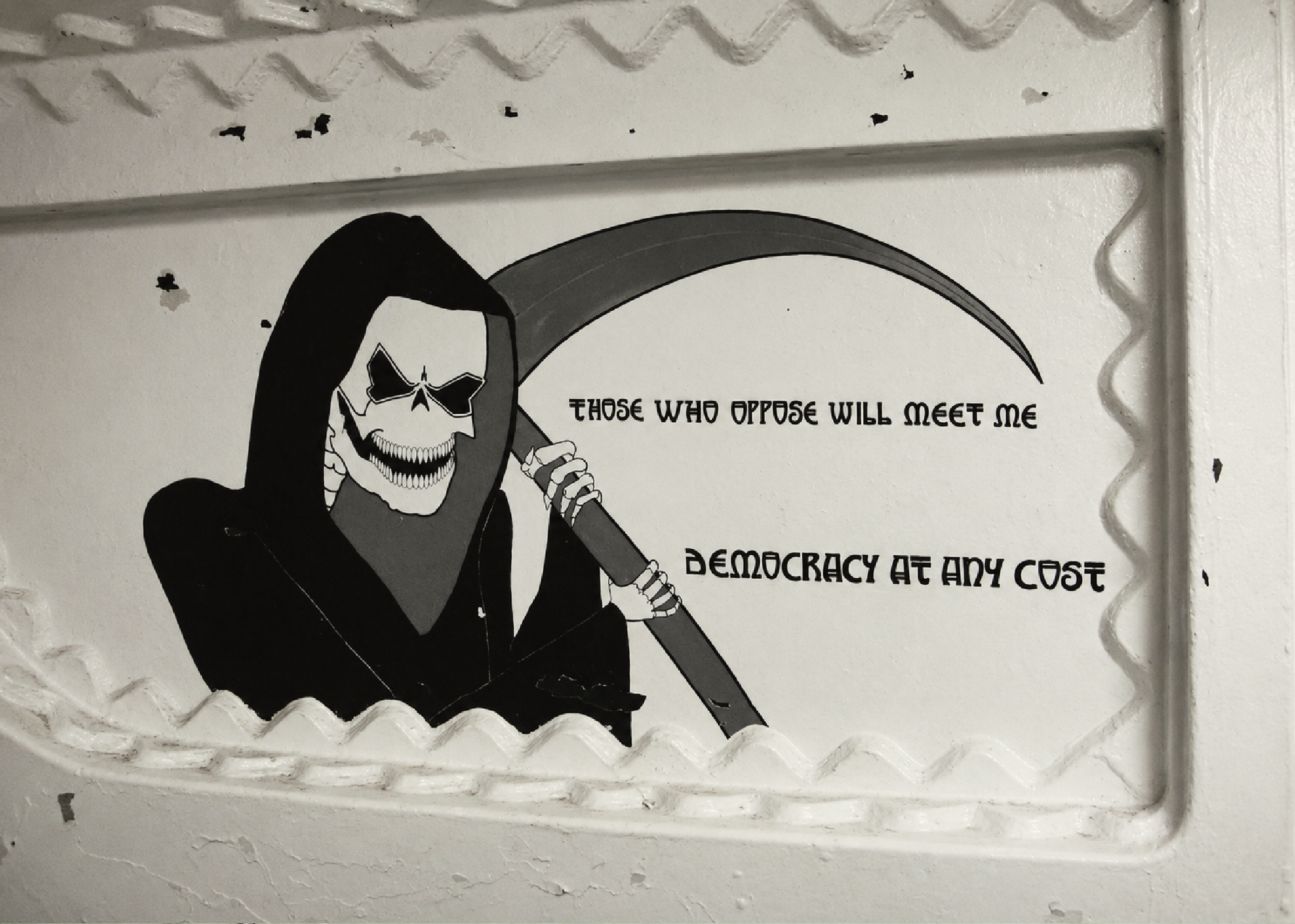 Grim Reaper artwork inside the Battleship New Jersey with the phrases “Those Who Oppose Will Meet Me” and “Democracy at Any Cost.”