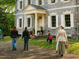Visitors and a living-history interpreter walk toward Upsala Mansion in Germantown during the Revolutionary Germantown Festival.