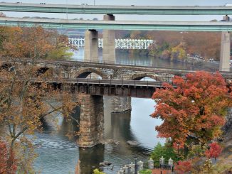 Five East Falls bridges cross the Schuylkill River, including historic railroad arches, the Twin Bridges and the distant Falls Bridge.