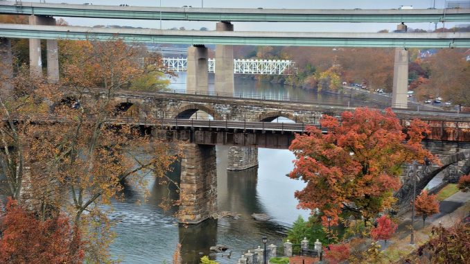 Five East Falls bridges cross the Schuylkill River, including historic railroad arches, the Twin Bridges and the distant Falls Bridge.