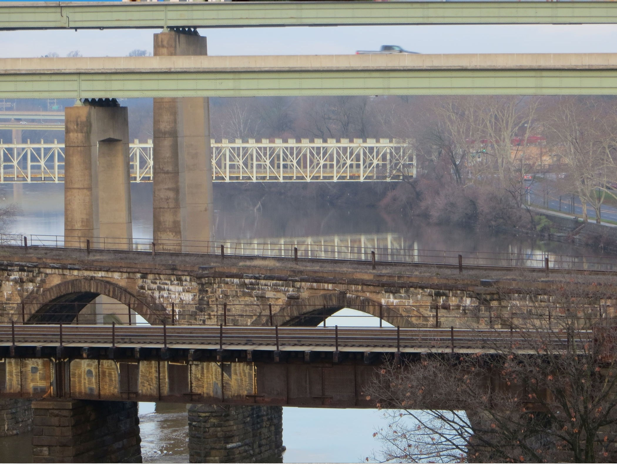 Five East Falls bridges appear in layers along the Schuylkill River, with historic railroad crossings, the Twin Bridges and the distant Falls Bridge.